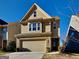 Two-story home featuring a brick and siding exterior, attached garage, and well-maintained landscaping under a bright sky at 3713 Upland Dr, Mcdonough, GA 30253