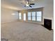 Spacious living room boasts neutral carpet, abundant natural light, ceiling fan, and a cozy fireplace, perfect for relaxation at 3713 Upland Dr, Mcdonough, GA 30253