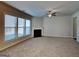 Bright living room featuring neutral carpet, a ceiling fan, a fireplace, and large windows providing ample natural light at 3713 Upland Dr, Mcdonough, GA 30253