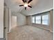 Spacious main bedroom featuring neutral walls, carpet, ceiling fan, a walk in closet, and abundant natural light at 3713 Upland Dr, Mcdonough, GA 30253