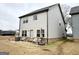 View of the home's backyard with patio, seating, and well-manicured lawn at 2275 Church St, Hampton, GA 30228