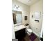 Powder room features a vanity with granite countertop and decorative wall art at 2275 Church St, Hampton, GA 30228