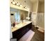 Bathroom featuring double sinks, granite countertops, and modern lighting fixtures at 2275 Church St, Hampton, GA 30228