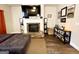 Living room showcasing a fireplace with white mantel and a large TV above at 2275 Church St, Hampton, GA 30228