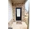 Inviting front door with brick surround and welcome mat at 2275 Church St, Hampton, GA 30228