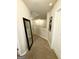 Upstairs hallway with carpet flooring, neutral walls, and a large decorative mirror at 2275 Church St, Hampton, GA 30228