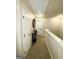 Upstairs hallway featuring carpeted flooring, neutral paint, and linen closet at 2275 Church St, Hampton, GA 30228