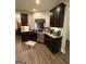 Well-equipped kitchen with stainless steel appliances and dark wood cabinets at 2275 Church St, Hampton, GA 30228