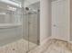 Modern bathroom featuring a glass-enclosed shower and tiled floors at 108 Mulberry Ct, Peachtree City, GA 30269