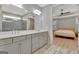 Bathroom with double vanity, quartz countertops, and an open doorway into the bedroom at 108 Mulberry Ct, Peachtree City, GA 30269