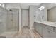 Modern bathroom featuring double vanity, quartz countertops, and a glass-enclosed shower at 108 Mulberry Ct, Peachtree City, GA 30269