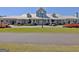 View of the well-maintained community clubhouse with ample parking and beautiful landscaping at 108 Mulberry Ct, Peachtree City, GA 30269