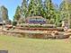 Attractive community entrance with stone features, colorful flowers, and lush greenery at 108 Mulberry Ct, Peachtree City, GA 30269