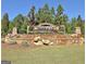 Attractive community entrance with stone features, beautiful flowers, and lush greenery at 108 Mulberry Ct, Peachtree City, GA 30269