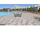 The community pool is surrounded by chair seating and tables for relaxing at 108 Mulberry Ct, Peachtree City, GA 30269