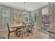 Stylish dining area with a wooden table, shuttered windows, and access to the screened-in porch at 108 Mulberry Ct, Peachtree City, GA 30269