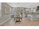Open-concept dining area with modern lighting, wood flooring, and seamless flow into the kitchen at 108 Mulberry Ct, Peachtree City, GA 30269