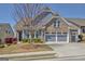 Charming two-story home with a two-car garage, blue siding, brick accents, and landscaped front yard at 108 Mulberry Ct, Peachtree City, GA 30269