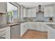 Modern kitchen featuring white cabinets, stainless steel appliances, and granite countertops at 108 Mulberry Ct, Peachtree City, GA 30269