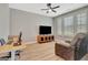Cozy home office with a ceiling fan, hardwood floors, bright light, and a comfortable recliner at 108 Mulberry Ct, Peachtree City, GA 30269