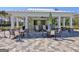 Outdoor covered area features seating for residents and guests around several tables near the pool at 108 Mulberry Ct, Peachtree City, GA 30269