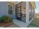 Inviting screened porch featuring an outdoor grill and comfortable wood seating, perfect for relaxation at 108 Mulberry Ct, Peachtree City, GA 30269