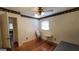 Spare bedroom featuring hardwood floors, a window, and neutral walls, offering a simple and functional space at 617 Virginia Cir, Forest Park, GA 30297