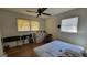 Bedroom with wood floor, two windows, ceiling fan, and blinds at 617 Virginia Cir, Forest Park, GA 30297