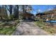 Exterior view of a carport with a concrete driveway, nestled in a yard with mature trees at 617 Virginia Cir, Forest Park, GA 30297