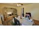 A dining room featuring hardwood floors, a ceiling fan, and an opening to an adjacent living space at 617 Virginia Cir, Forest Park, GA 30297