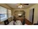 Bright dining area with hardwood floors and a large window looking onto an adjacent room at 617 Virginia Cir, Forest Park, GA 30297