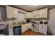 Functional kitchen features white cabinets, a double sink, and modern appliances at 617 Virginia Cir, Forest Park, GA 30297