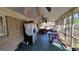 A view of the enclosed porch showcasing a brick wall, table, and wooden floor at 617 Virginia Cir, Forest Park, GA 30297