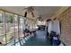 Enclosed porch featuring a wooden floor, ceiling fans, and views of the surrounding trees at 617 Virginia Cir, Forest Park, GA 30297