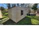 Shed with a window and door, situated on a grassy lawn with surrounding trees at 617 Virginia Cir, Forest Park, GA 30297