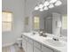Bright bathroom featuring double sinks, tile floor, and ample vanity storage at 116 Evenview Dr., Jonesboro, GA 30236