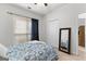 Comfortable bedroom featuring neutral carpet, a ceiling fan, a window, and a mirror at 116 Evenview Dr., Jonesboro, GA 30236