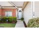 Inviting front entrance with a white door, manicured bushes, and well kept lawn at 116 Evenview Dr., Jonesboro, GA 30236