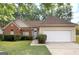 Charming home featuring a brick facade, well-manicured lawn, and an attached two-car garage at 116 Evenview Dr., Jonesboro, GA 30236