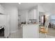 Open-concept kitchen with white cabinets, breakfast bar, and view to the living area at 116 Evenview Dr., Jonesboro, GA 30236