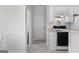This kitchen features an oven, white cabinets, and access to a laundry room and back door at 116 Evenview Dr., Jonesboro, GA 30236