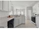 Functional kitchen with white cabinetry and appliances, and a view into the dining area at 116 Evenview Dr., Jonesboro, GA 30236