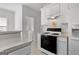Efficient kitchen featuring white appliances and a connecting laundry area and breakfast nook at 116 Evenview Dr., Jonesboro, GA 30236