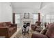 Spacious living area featuring a fireplace and plush seating arrangement on patterned rug at 116 Evenview Dr., Jonesboro, GA 30236