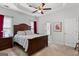 Main bedroom with a tray ceiling, ceiling fan, and red drapes at 116 Evenview Dr., Jonesboro, GA 30236