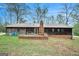 Exterior of the home with a brick patio and spacious backyard, perfect for outdoor entertaining at 4230 Iris Brooke Ln, Snellville, GA 30039