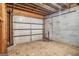 Unfinished basement with garage door providing easy access for storage or workshop space at 4230 Iris Brooke Ln, Snellville, GA 30039