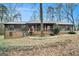 Charming home with a covered porch, wooden siding, and well-maintained landscaping in front at 4230 Iris Brooke Ln, Snellville, GA 30039