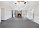 Bright living room featuring a stone fireplace, carpeted floors, and natural light at 4230 Iris Brooke Ln, Snellville, GA 30039