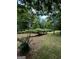 Spacious backyard features lush greenery with mature trees providing plenty of shade for outdoor enjoyment at 281 New Hope Dr, Mcdonough, GA 30252